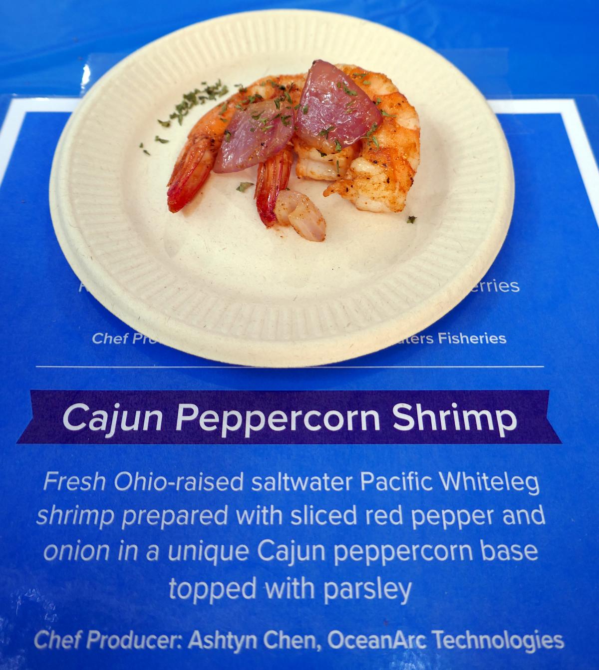 Cajun peppercorn shrimp on a paper plate.